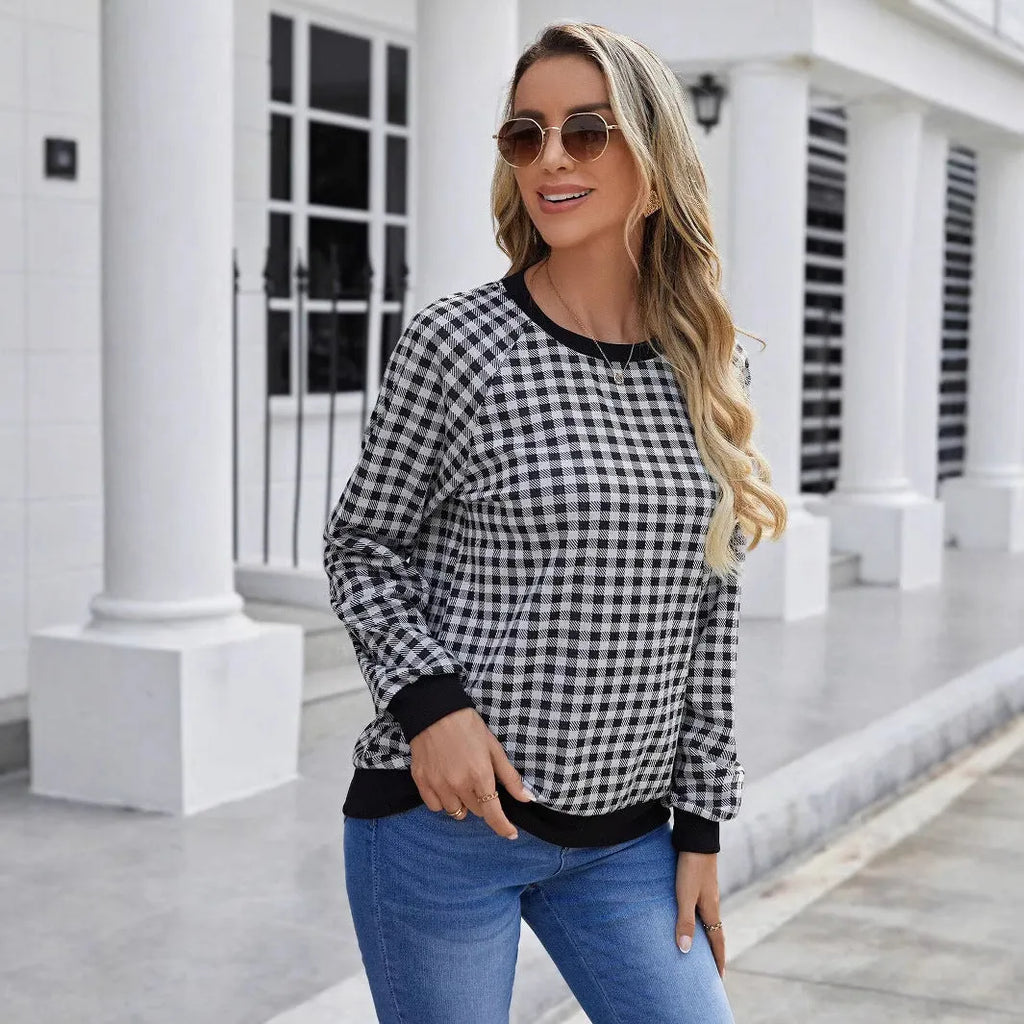 Black long sleeve pullover sweater with printed plaid and stripe pattern design.