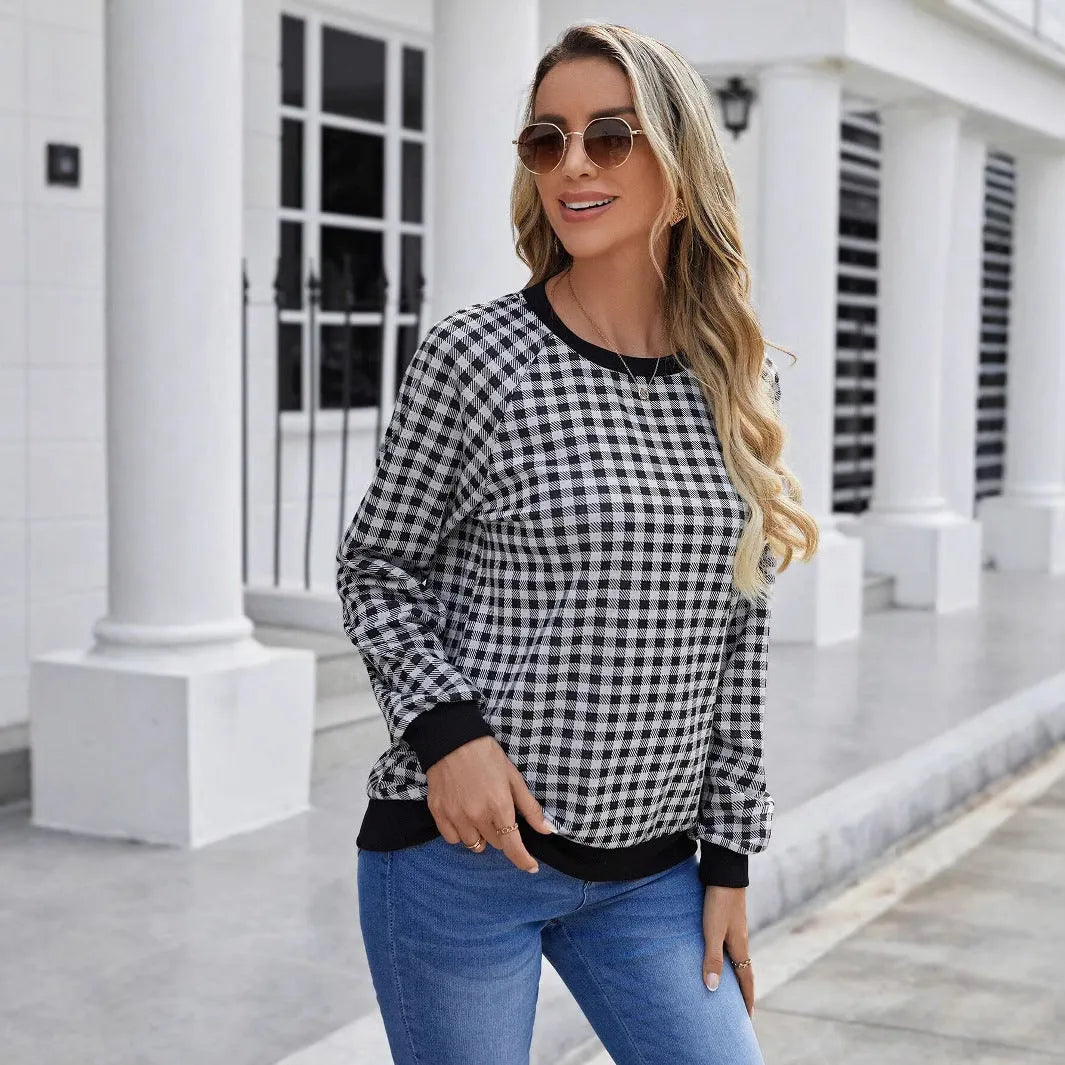 Black long sleeve pullover sweater with printed plaid and stripe pattern design.