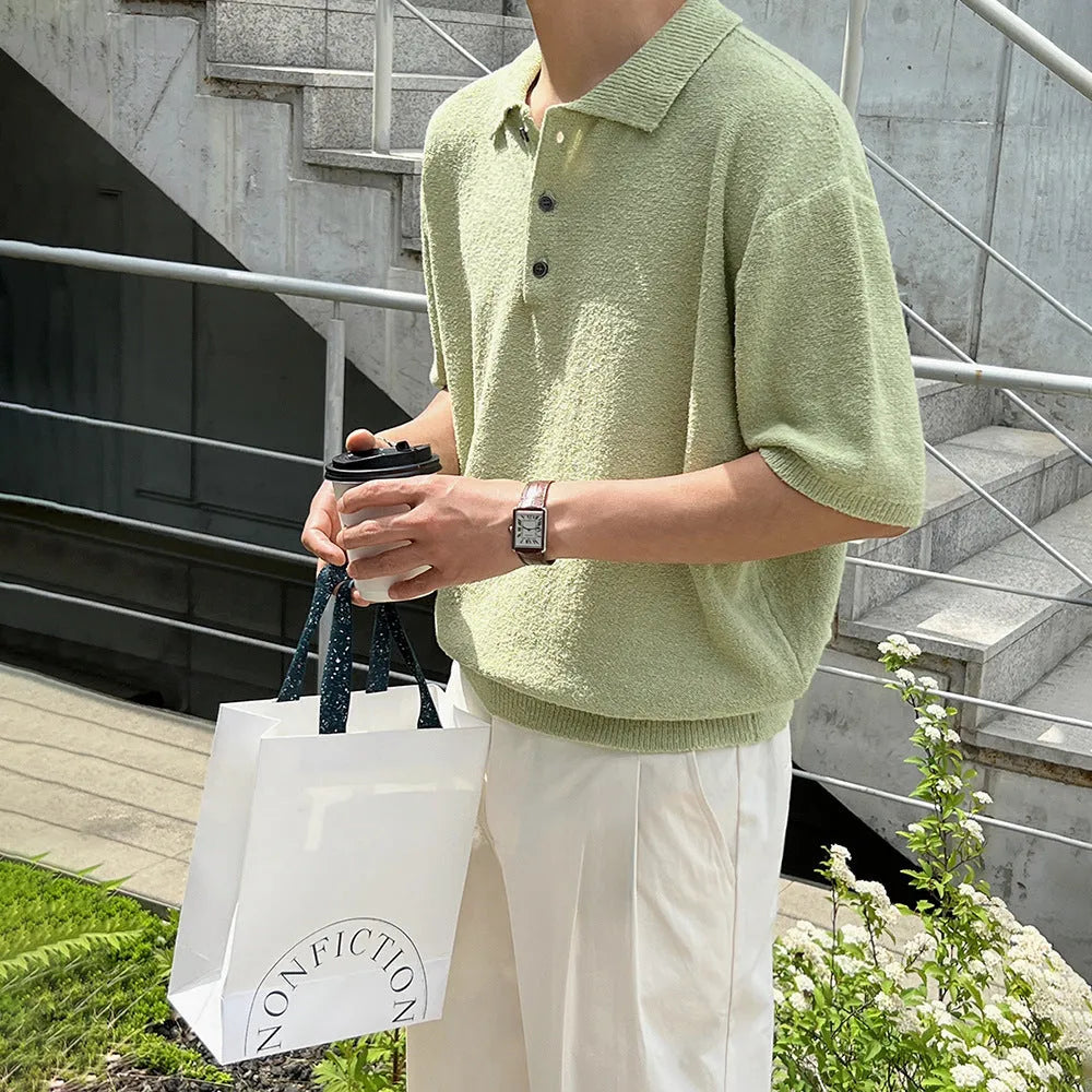 Man wearing a caramel coloured retro knitted polo shirt with short sleeves and an asymmetric design detail.