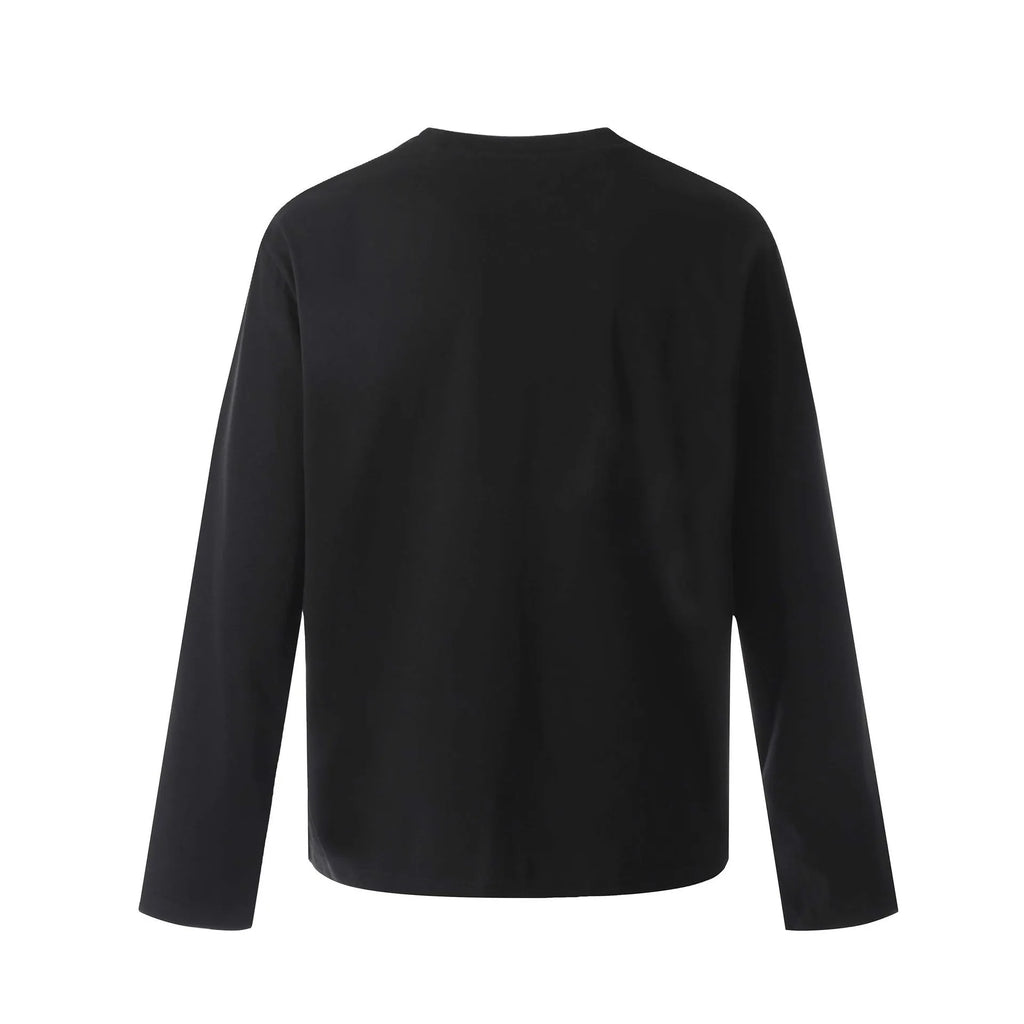 A loose-fitting long sleeve cotton pullover in grey, shown on a model for casual wear.