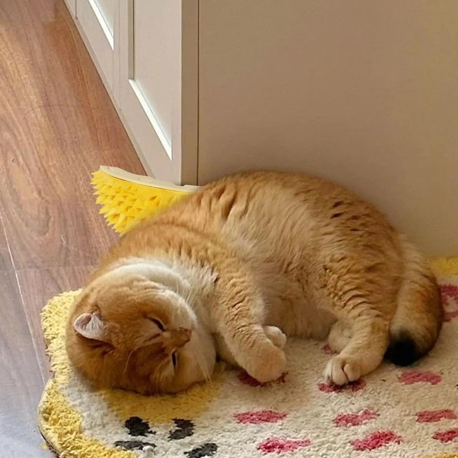 Yellow durian-shaped cat corner scratcher mounted on a wall with adhesive, includes catnip powder.