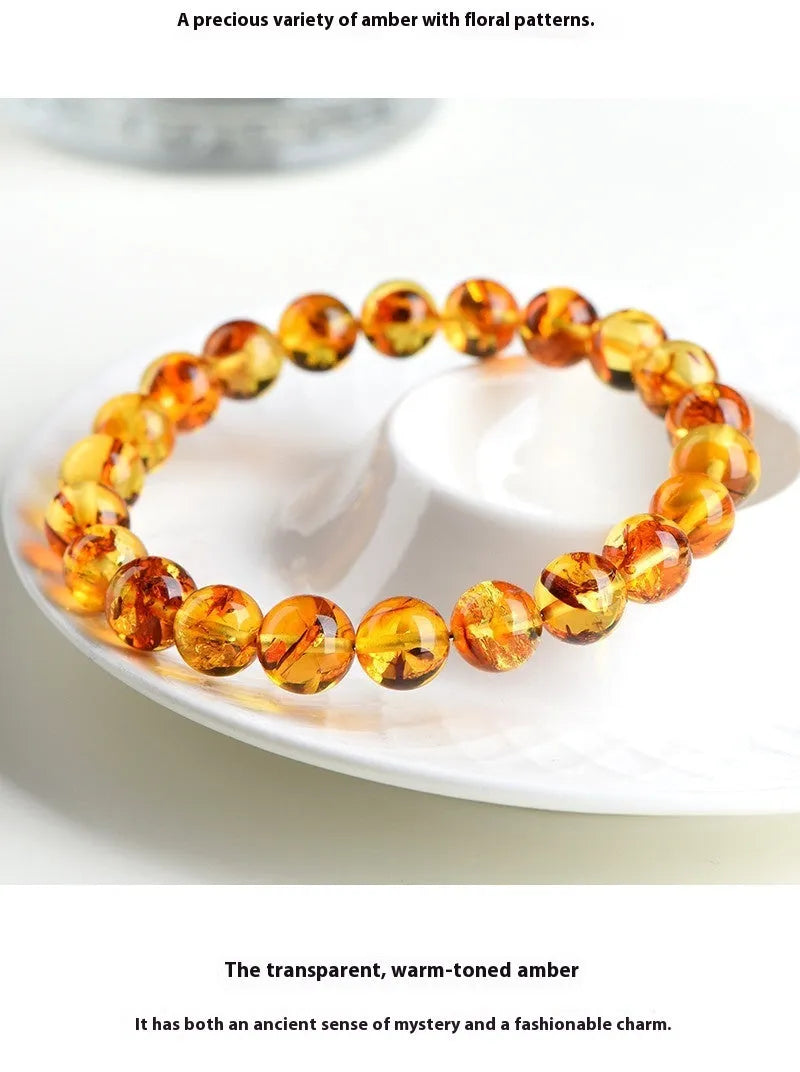 Natural yellow piebald amber bracelet with geometric beads showing distinctive flower spot patterning