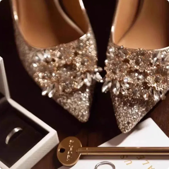 Champagne Xiuhe wedding shoes with rhinestones, pointed toe, fine heel, and one foot kick closure.