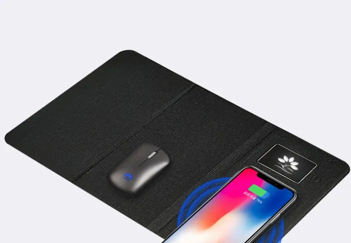 Folding wireless charging mouse pad set with luminous surface, black cloth pad, and wireless mouse on desk