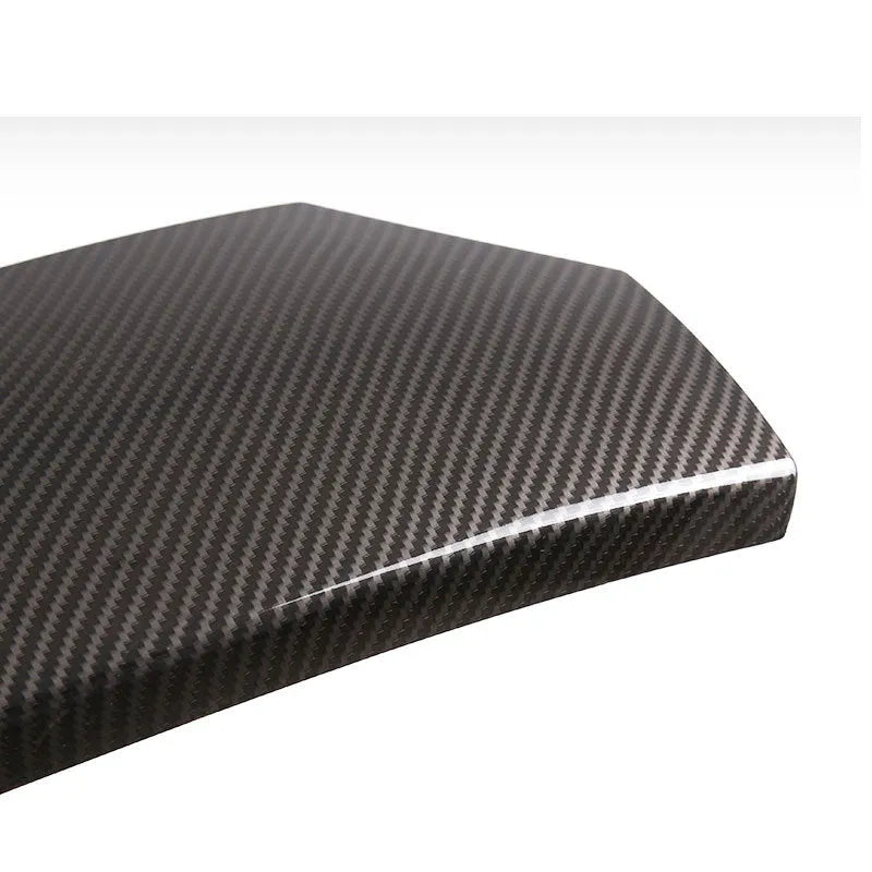 Three black ABS plastic car armrest box covers with a carbon fibre pattern and glossy finish.