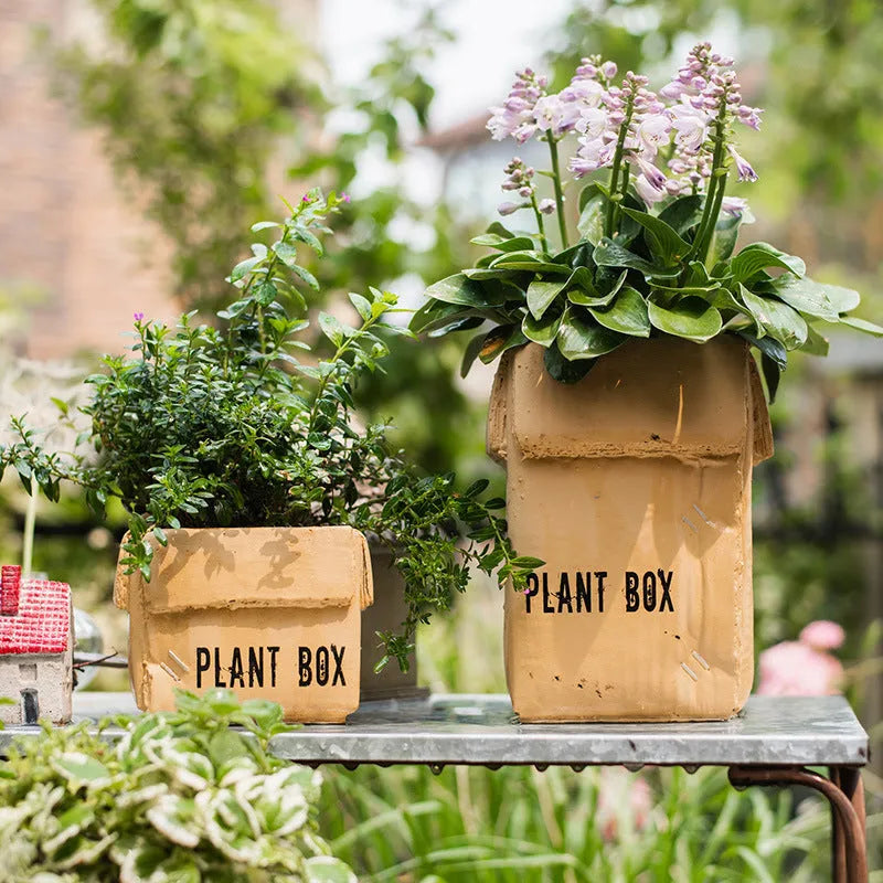 Cement flowerpot with brown paper box design and drainage holes for indoor planting