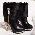 Women's black ankle boot with a chunky high heel on a white background, showing the artificial PU leather upper.