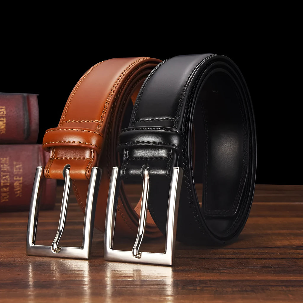 Men's black genuine leather belt with a silver alloy pin buckle fastened, showing glossy patent leather finish.