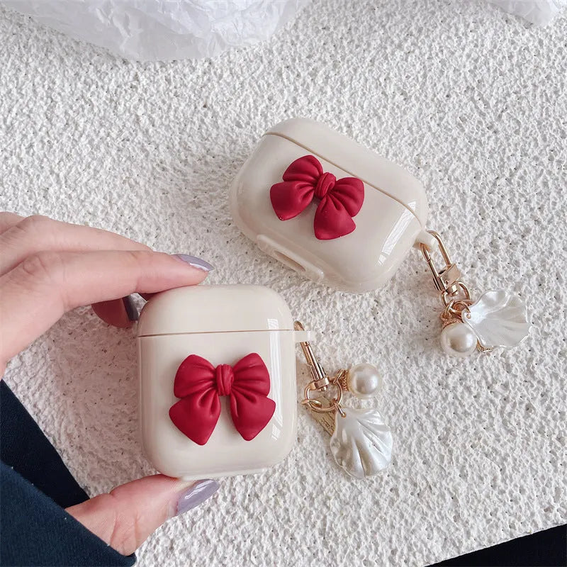 Beige red bow shell patterned TPU protective case for Apple AirPods Pro and AirPods 1, 2, 3 wireless earphones.