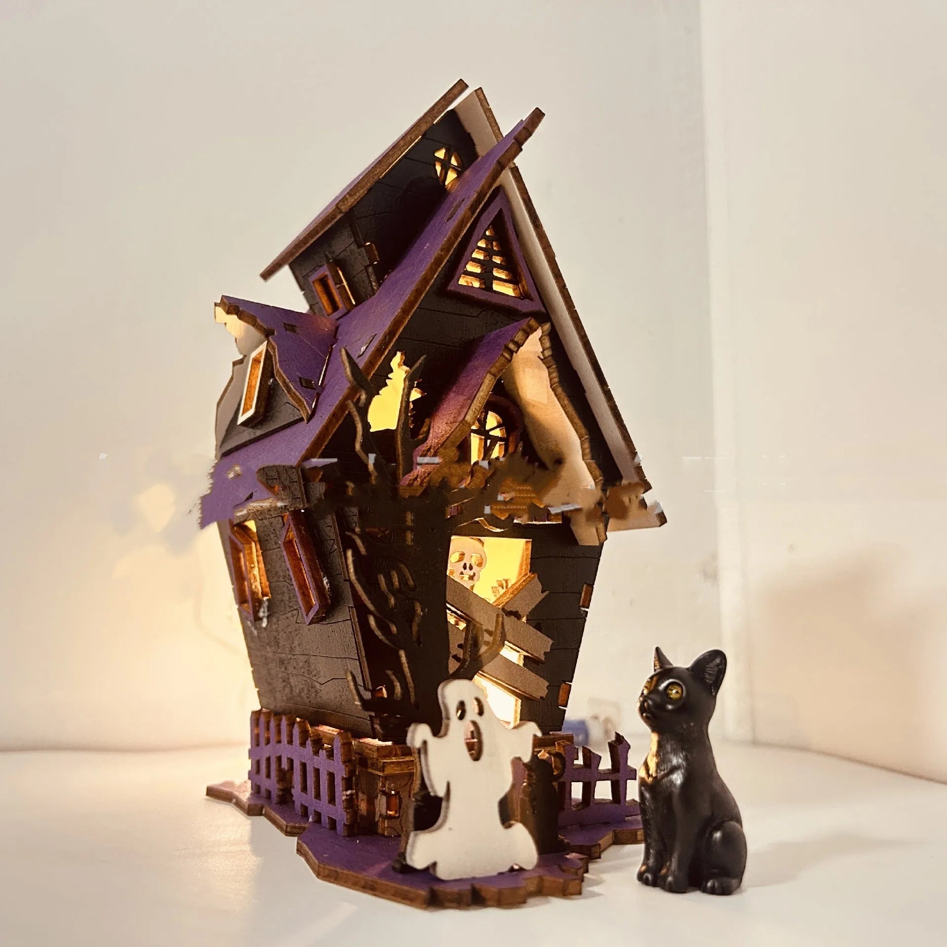 Unpainted wooden haunted house Halloween decoration measuring 14cm wide by 19cm tall