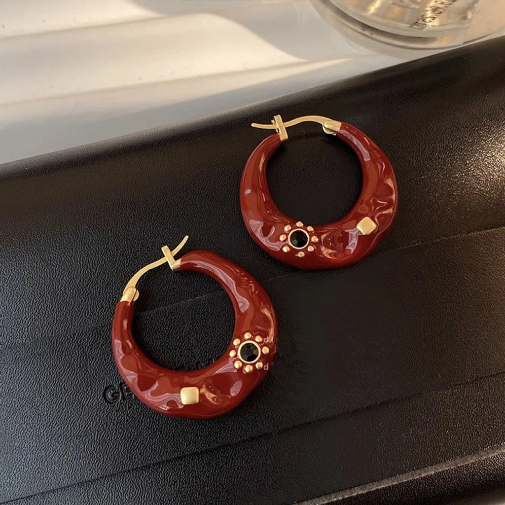 Hong Kong style retro ear studs with dripping oil finish and rhinestone accents in black and red colours
