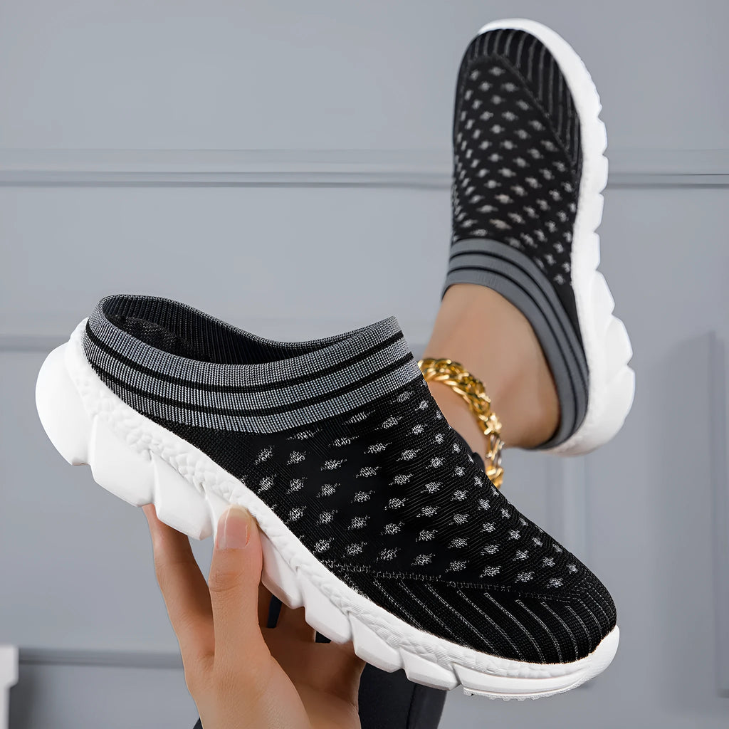 Women's striped Flyknit sports slipper in black with hollowed-out design and height-increasing sole.