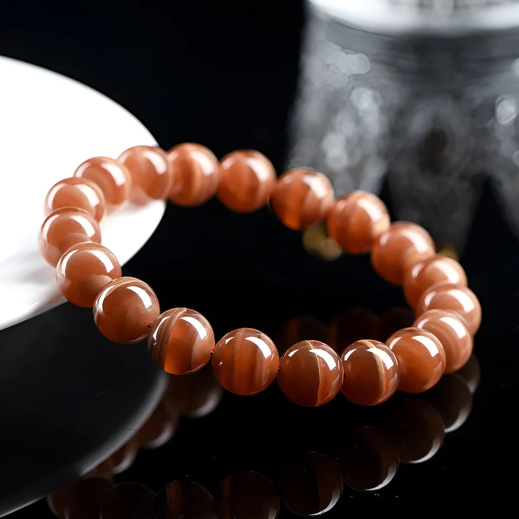 Natural Peruvian rhodochrosite bead bracelet with geometric design and ruyi element