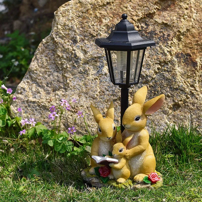 Decorative hexagonal solar garden lamp with animal sculpture design on patio.