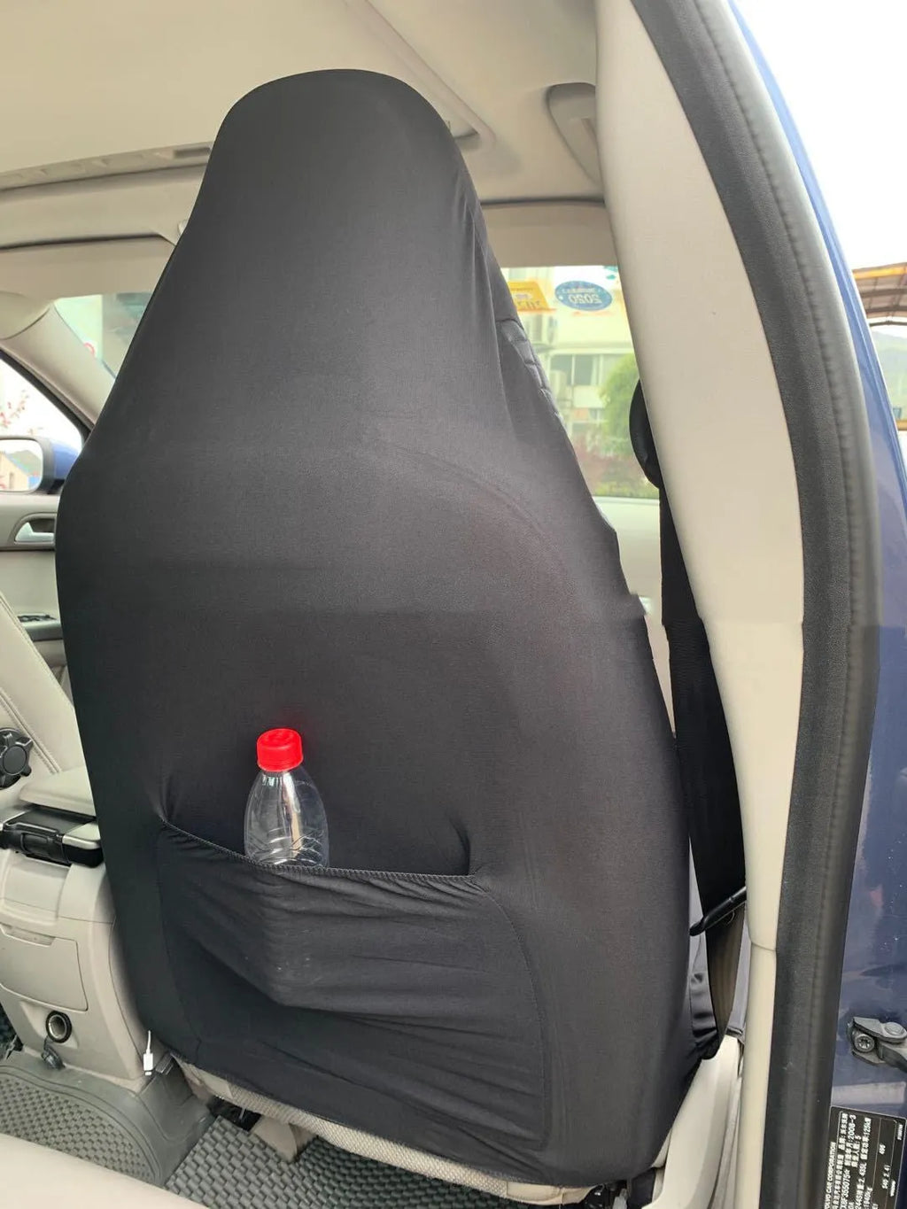 Black quilted automotive seat cover with plastic hook fasteners