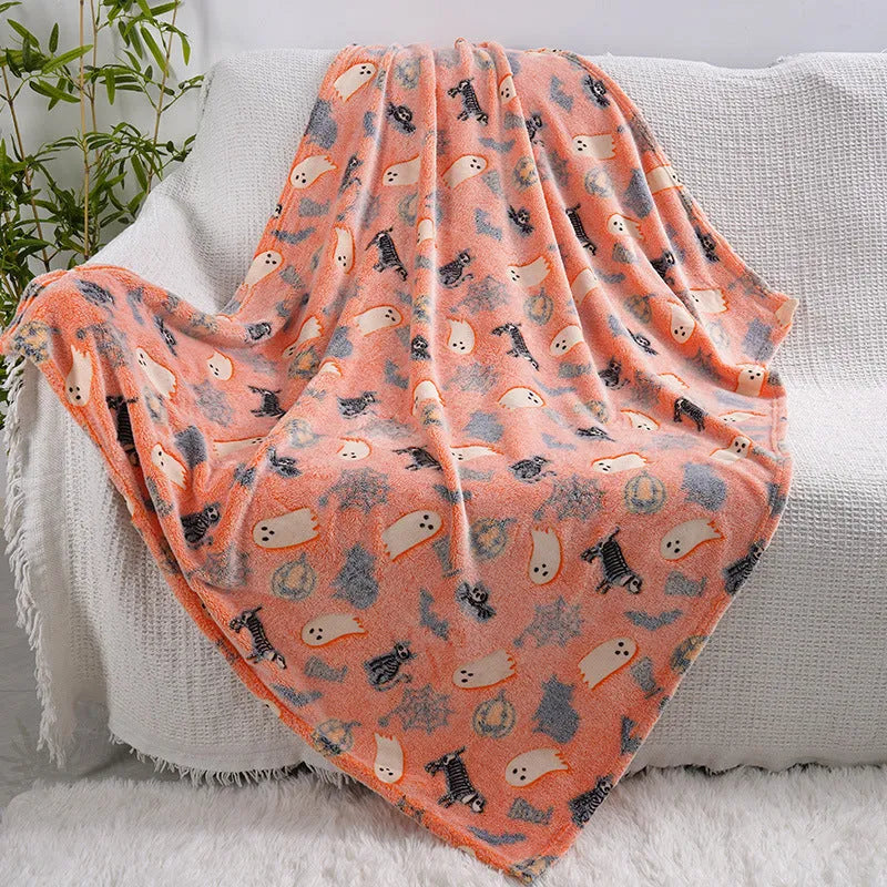 Cartoon style children's flannel blanket in two sizes on a child's bed.