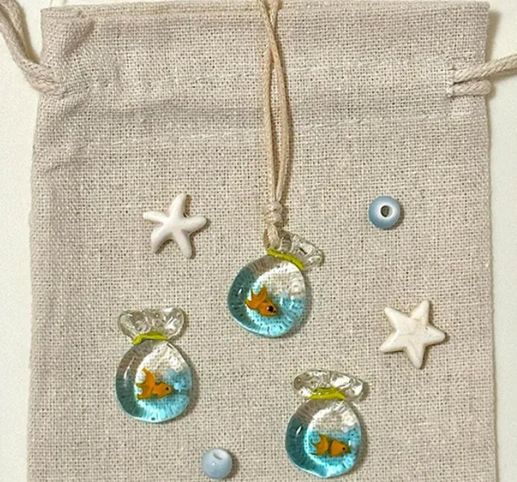 Women's joker charm pendant necklace in coloured glaze on a cotton and linen clavicle chain.