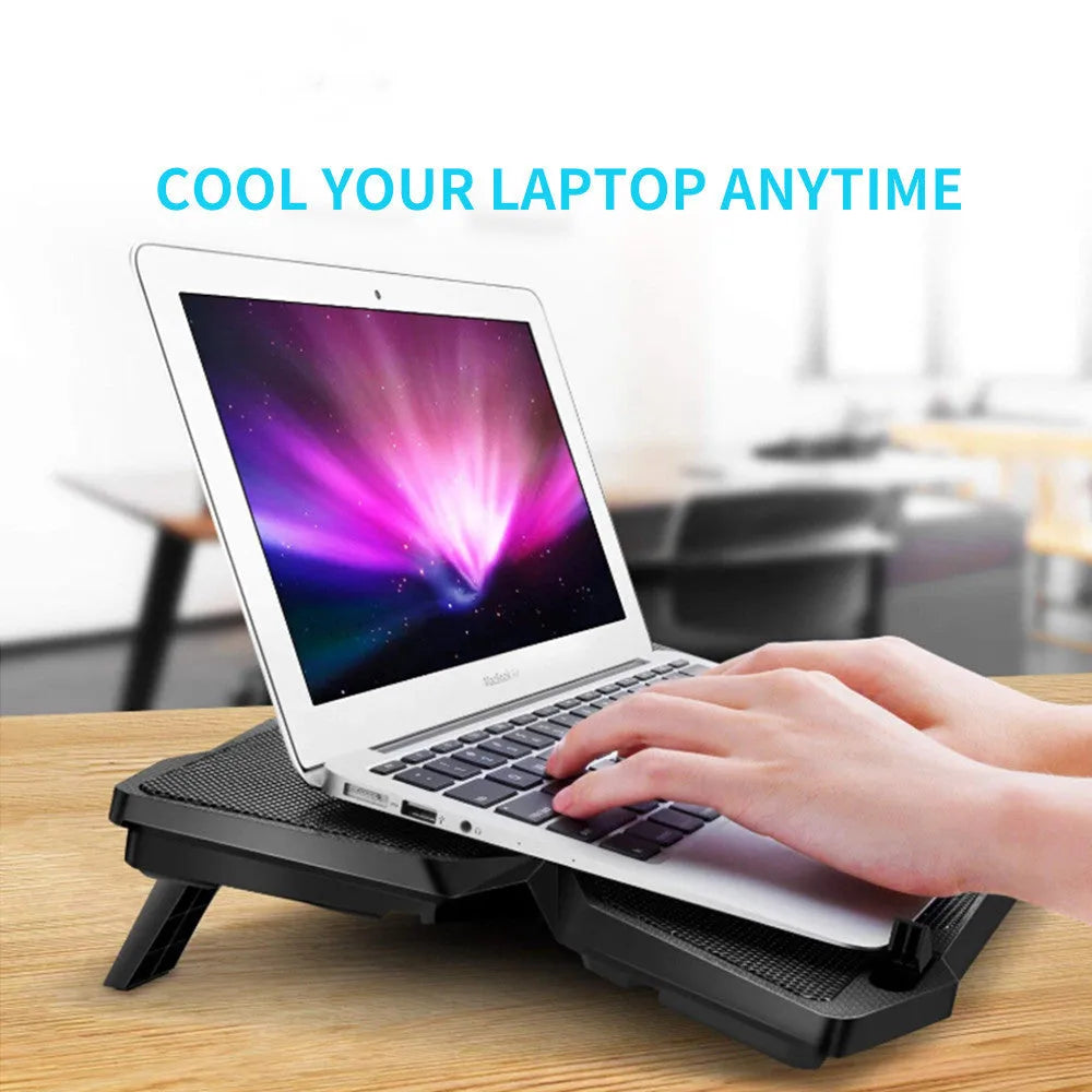 Blue laptop cooling pad with four LED fans and USB ports on a desk
