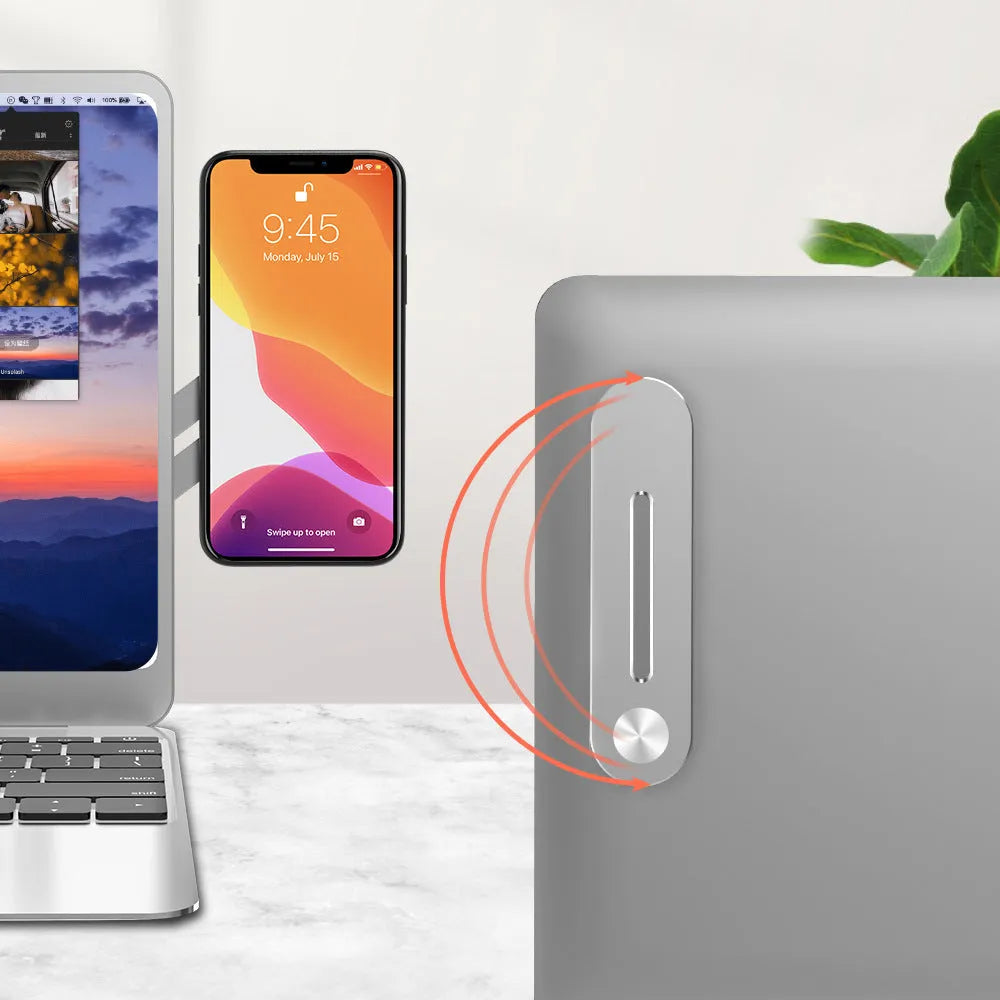 Aluminium alloy laptop side mount bracket holding a smartphone next to a laptop screen, with magnetic pad visible
