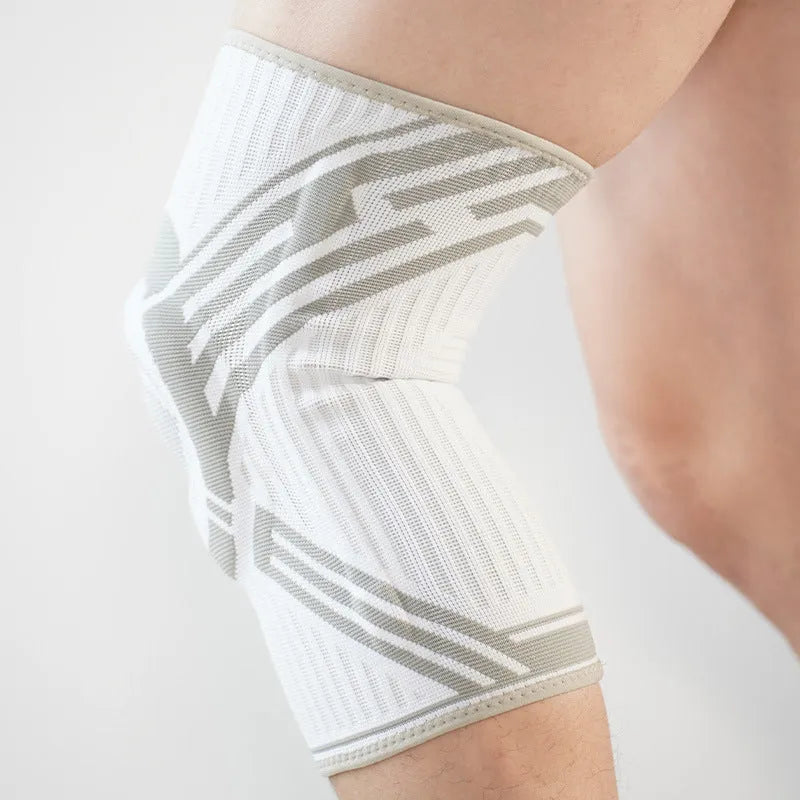 Adult elastic cotton knee pad for sports in blue, shown on a knee.