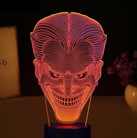 USB-powered 3D acrylic LED lamp showing seven colour options and remote control on a desk.