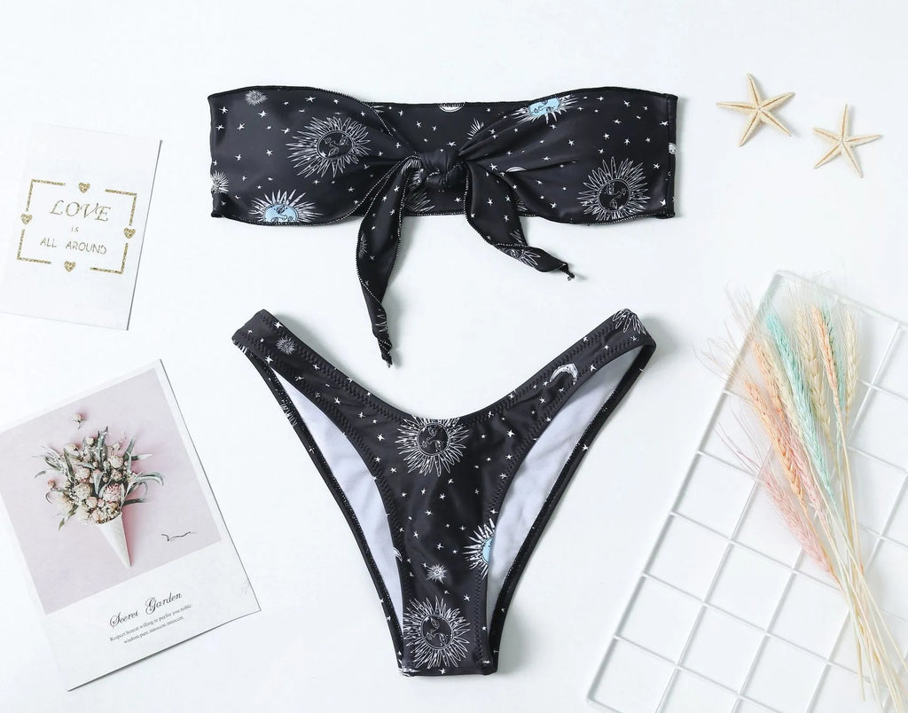 Black one-piece swimsuit with bikini print, featuring a split tube top and backless design.