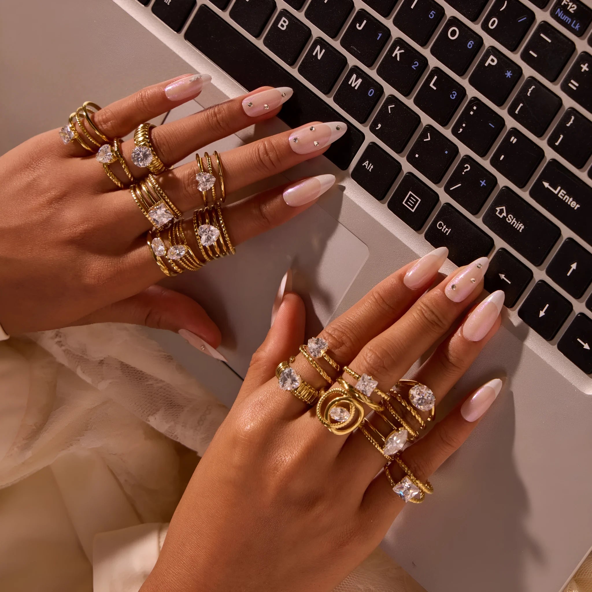 Gold electroplated geometric stainless steel ring with inlaid zircon stones on a finger, showing open mouth design.