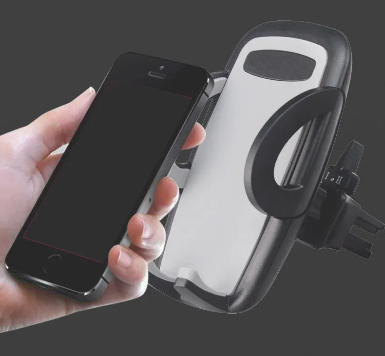 Black plastic car air vent mobile phone holder mounted on vehicle dashboard