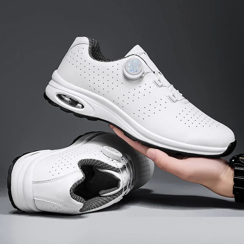 Black and white low top mesh tennis shoes with a round toe and flat composite sole on a plain background.