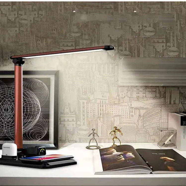 Black and white 4-in-1 LED desk lamp with wireless charging pad showing USB-C port