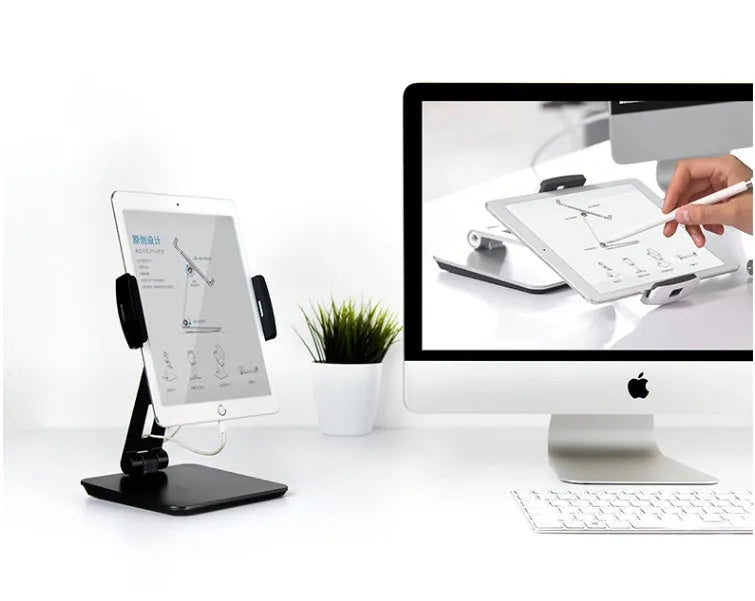 Silver folding aluminium phone and tablet stand with 360° rotation on wooden desk