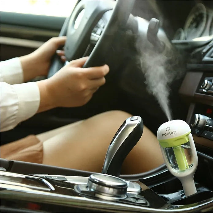 Portable mini car humidifier and essential oil diffuser with rotating nozzle in multiple colours.