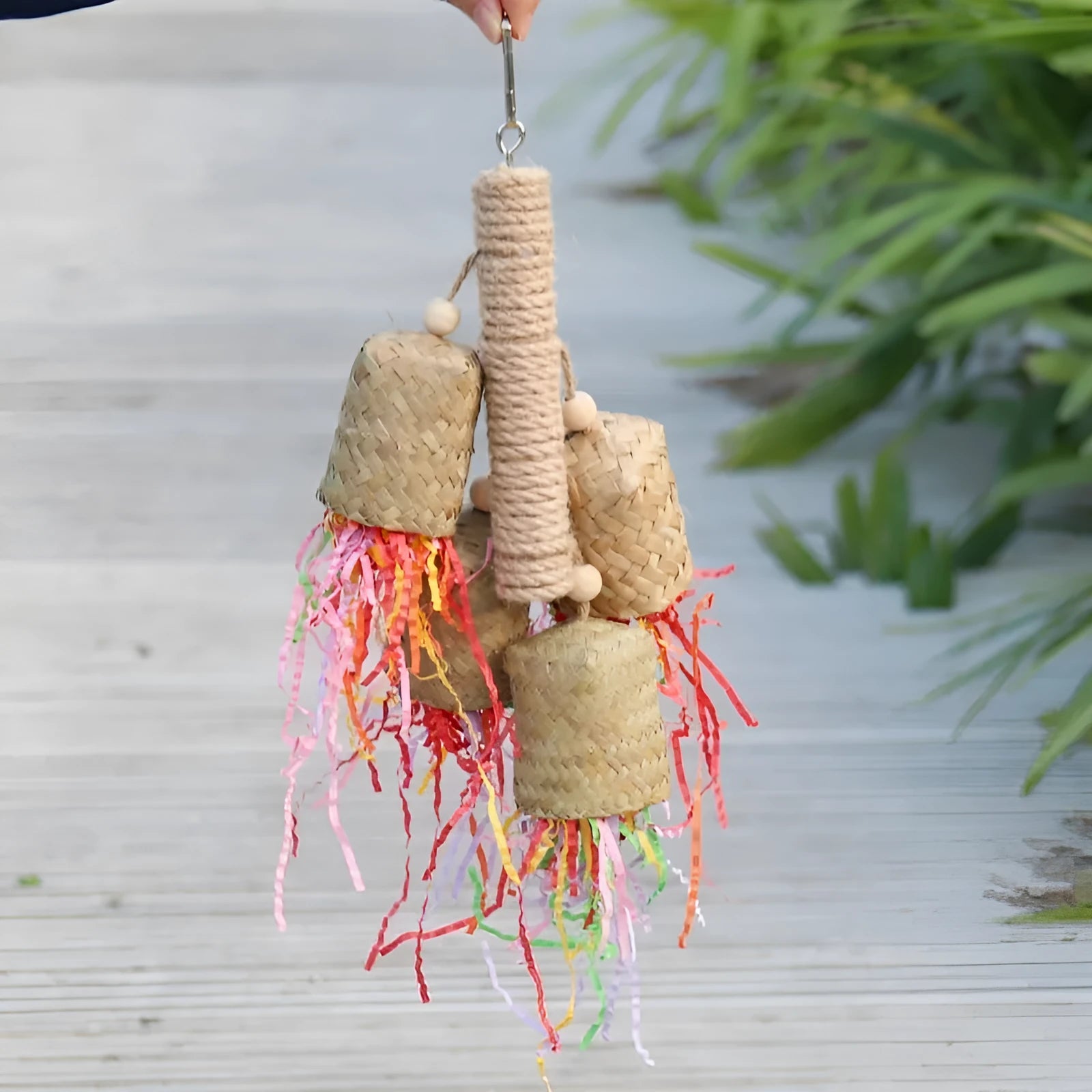 Wood and sisal parrot toy with shredded paper, measuring 15 by 35 centimetres
