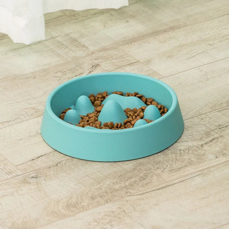 Pet slow food bowl with raised mountain bumps in off-white colour on a floor mat