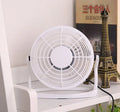 Mini black USB desk fan with adjustable angle for laptop cooling on wooden desk