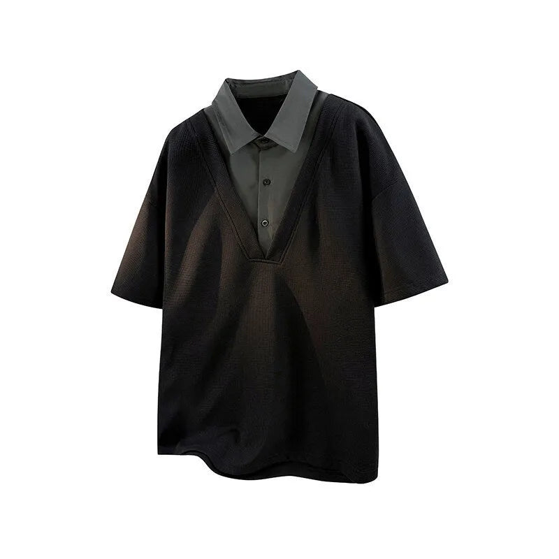 Man wearing a black heavy Henry collar short sleeve polo sweater with padding.