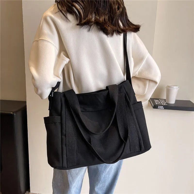 Polyester canvas shoulder bag in solid colour with internal mobile phone pocket organisation