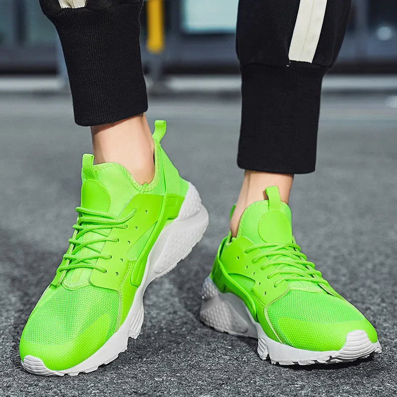 Men's green low-top casual shoes with mesh upper and cross shoulder straps on a flat sole.