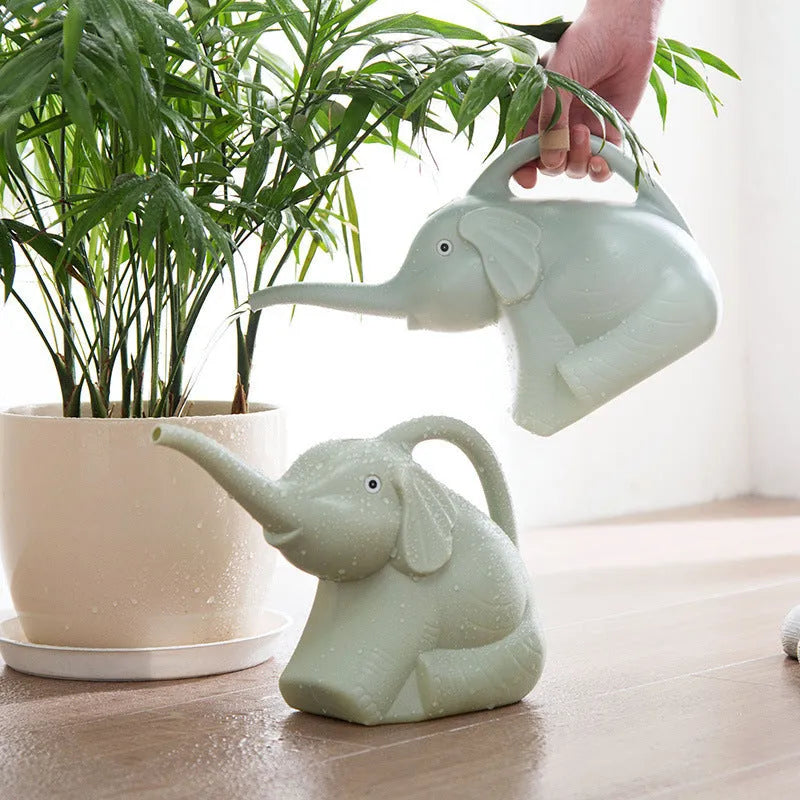 Pink elephant-shaped plastic watering can with a long nozzle for plant watering.