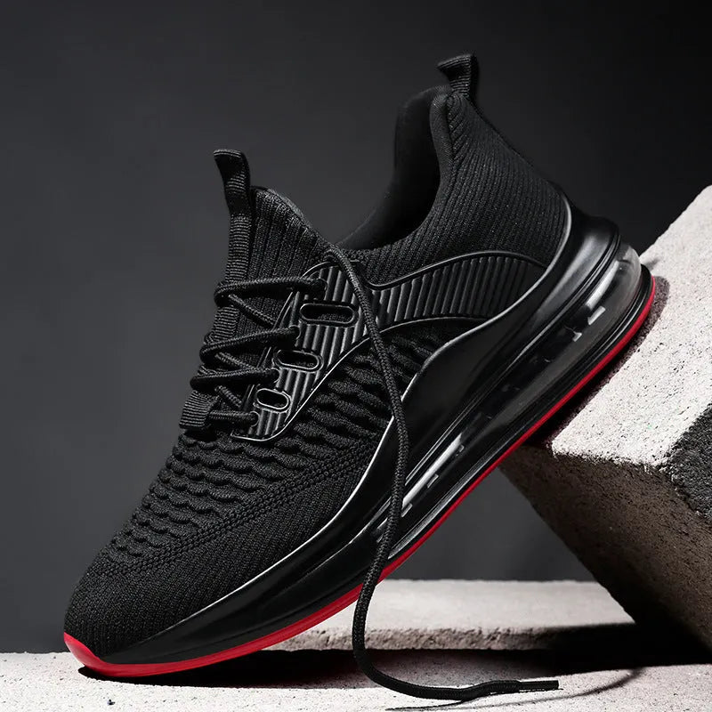 Men's black mesh low-top running shoes with white rubber sole on a plain background.