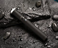 Black 7-in-1 desktop lamp selfie stick with LED lights, Bluetooth remote, and built-in tripod on a table