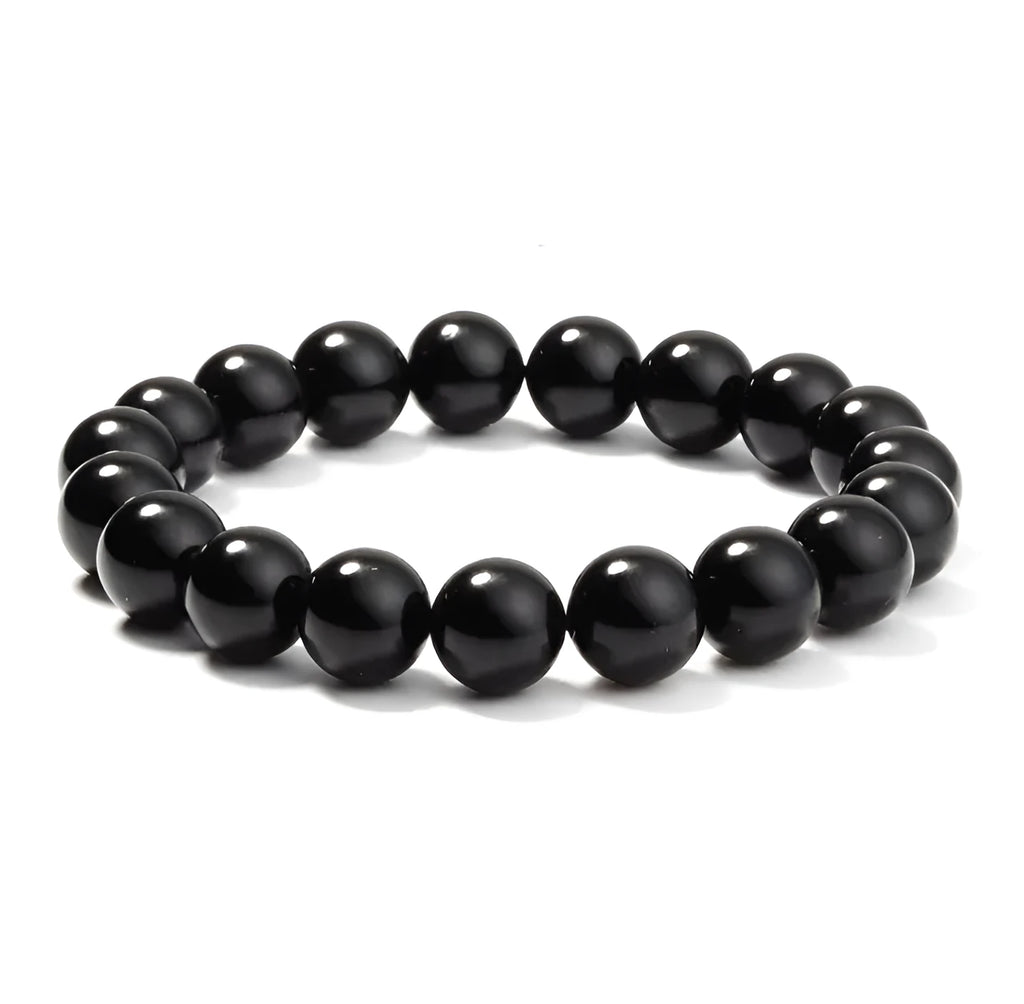 Women's black onyx agate beaded bracelet with geometric design and elastic cord.