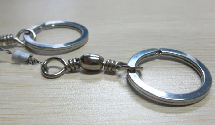 Stainless steel survival wire saw with thumb rings showing 55cm blade and compact storage size