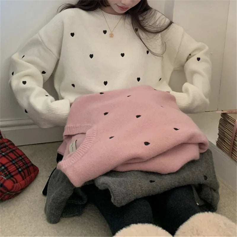 Women's loose grey acrylic pullover sweater with love pattern embroidery on the front.