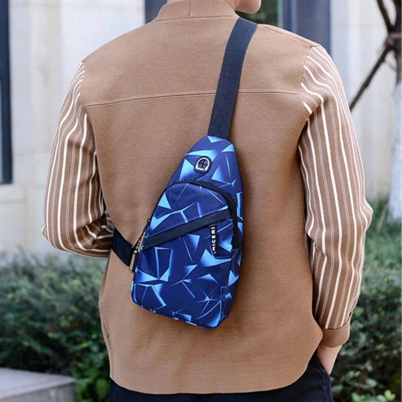 Men's blue Oxford cloth crossbody sling bag with an earphone hole and zipper, shown in a square vertical shape.