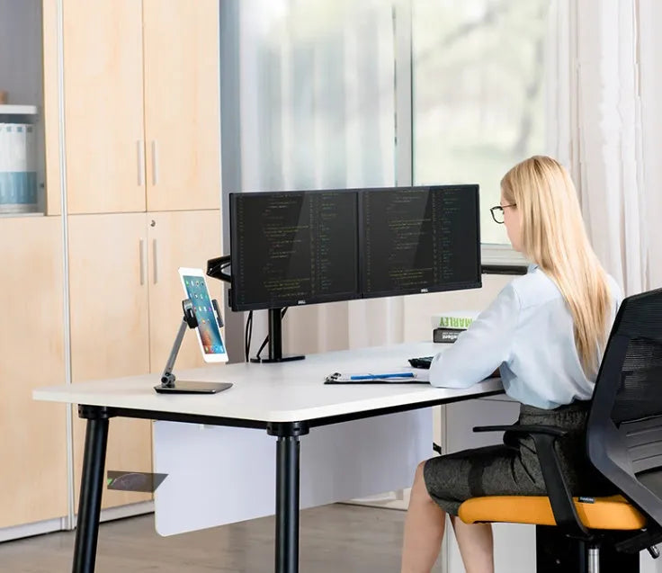 Silver folding aluminium phone and tablet stand with 360° rotation on wooden desk