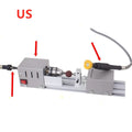 Mini silver metal woodworking lathe with carving knives on benchtop