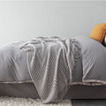 Small grey polyester nap blanket folded to show its 127x170cm size