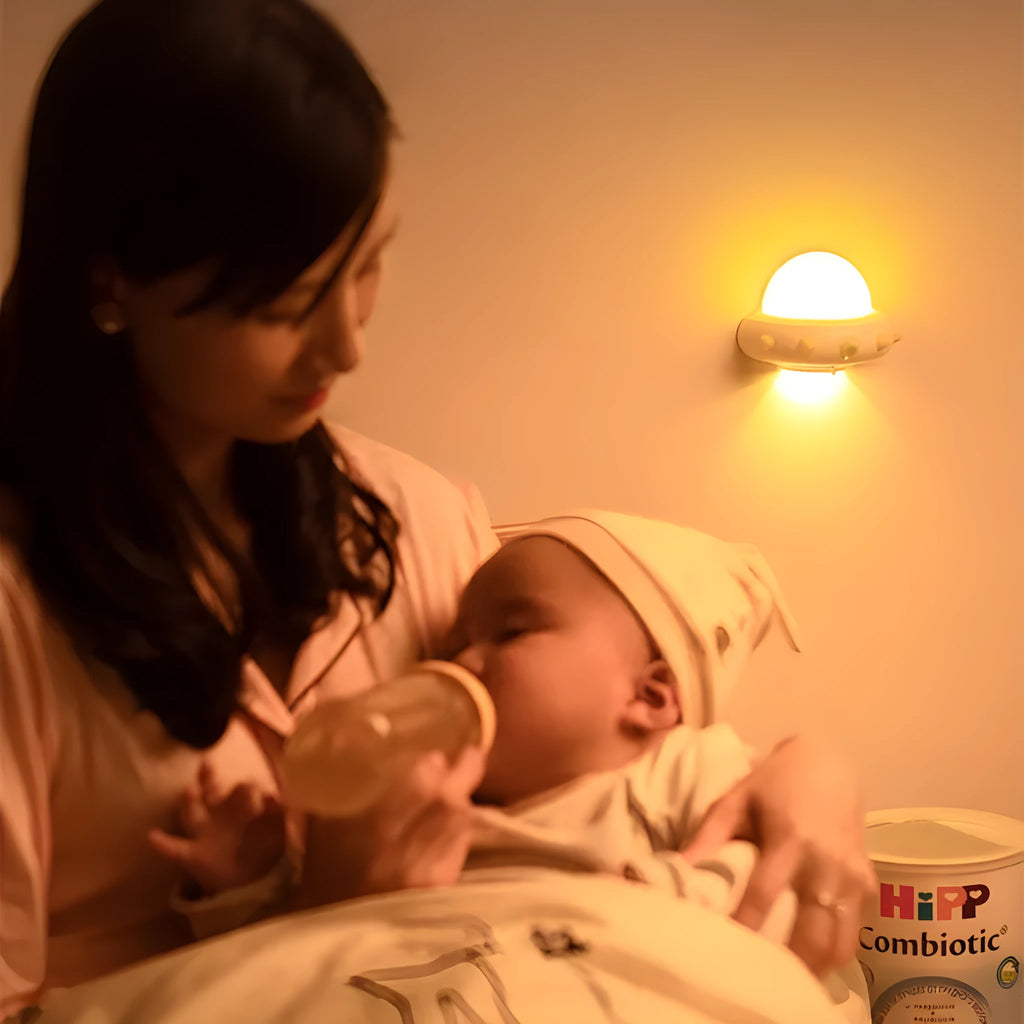 Remote control UFO-shaped bedside night light in blue, pink, or white colours.