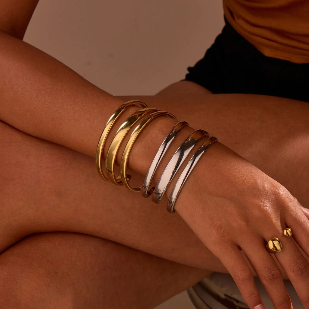 Stainless steel opening bracelet for women in gold or steel finish with geometric line design